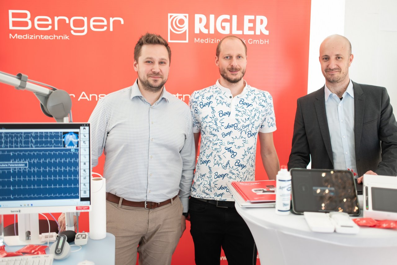 Drei Männer am Messestand