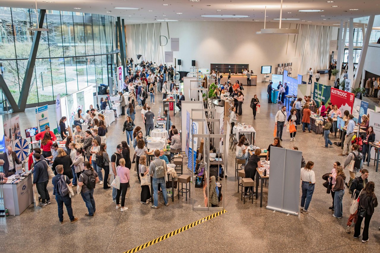 Halle mit Ständen und vielen jungen Menschen